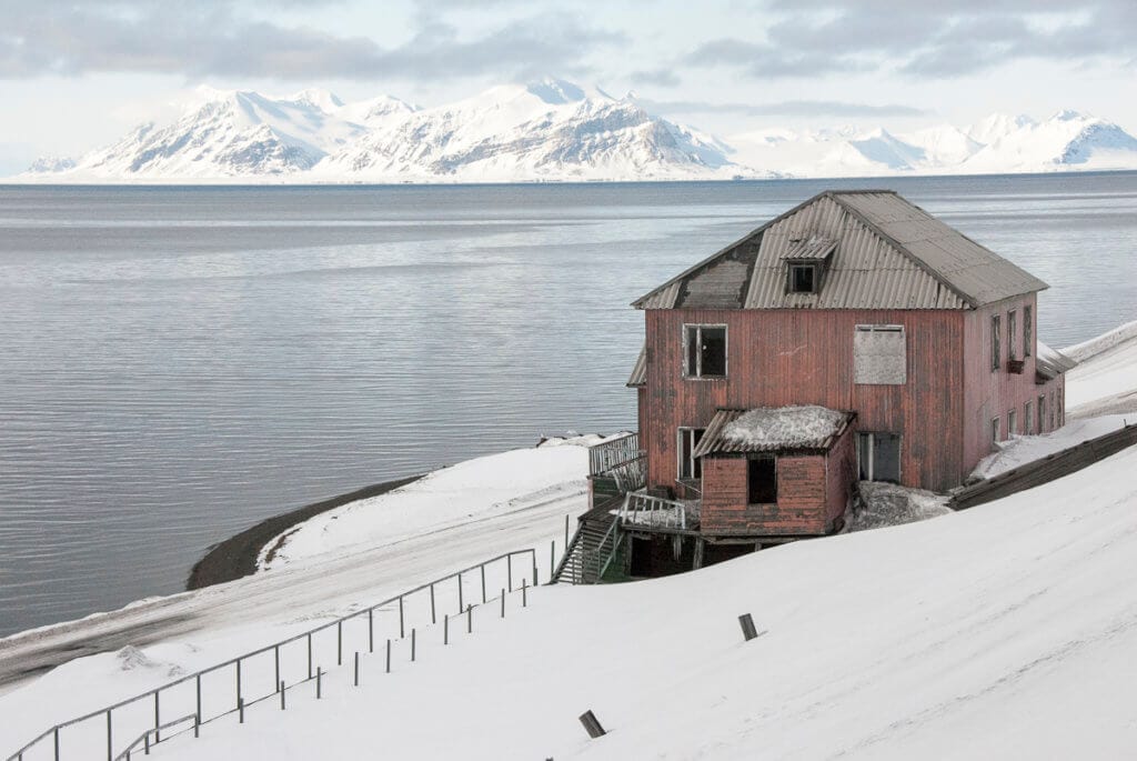 Polorozbořené budovy v přístavu v Barentsburgu